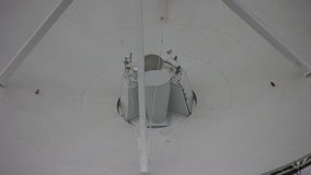 HD clip of a radio telescope antenna part of the Very Large Array of the National Radio Astronomy Observatory on the high plains of New Mexico, zooming out to a wider view of several dish antennas