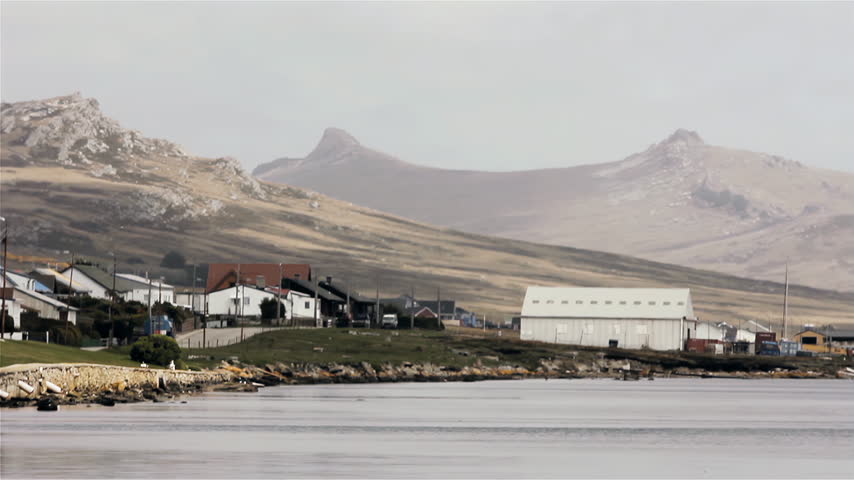 Truck Driving On Coastal Road With Two Sisters Mountains In Backdrop In Port Stanley, Falklands (Islas Malvinas) - 4K