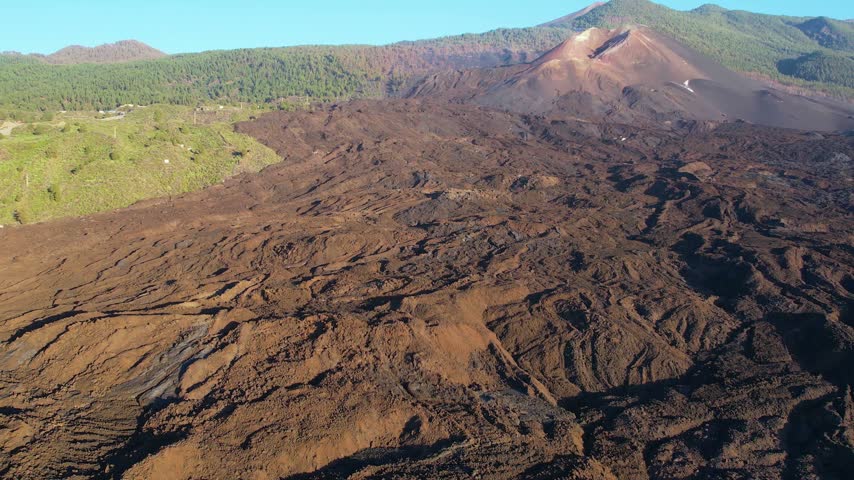 Aerial lava of Cumbre Vieja volcano two years after eruption with houses of small town on La Palma island Canary Islands Spain
