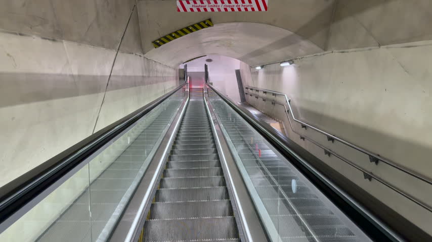 First person view escalator ride through an underground metro tunnel