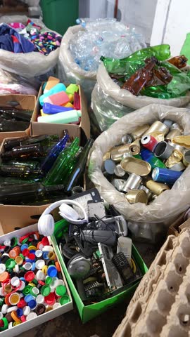  Household waste sorting by fractions including plastic, metal, paper, cardboard, glass, electronic waste, textiles, hazardous materials and batteries for recycling