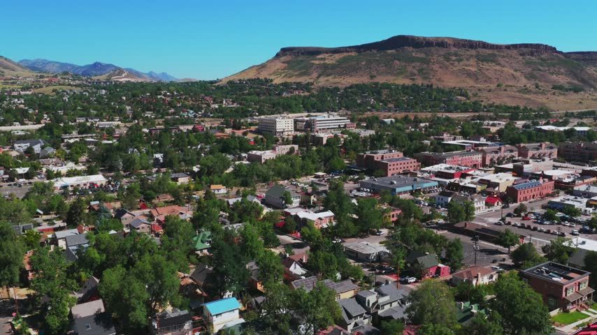 Downtown Golden historic West of Denver small town Colorado aerial drone Front Range Rocky Mountains Boulder Foothills summer morning blue sky sunny Table Mountain Mesa Clear Creek backwards pan up