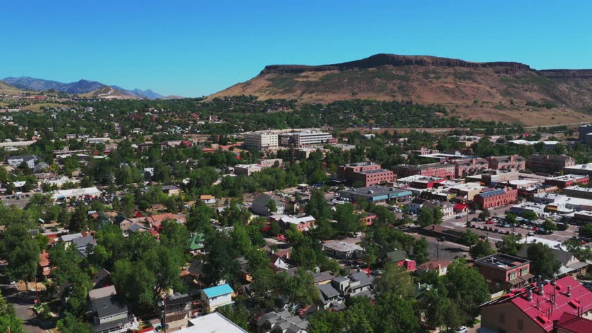 Downtown Golden historic West of Denver small town Colorado aerial drone Front Range Rocky Mountains Boulder Foothills summer morning blue sky sunny Table Mountain Mesa Clear Creek circle right motion