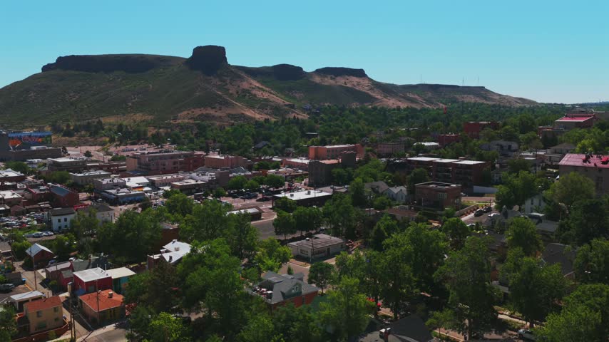 Downtown Golden historic West of Denver small town Colorado aerial drone Front Range Rocky Mountains Boulder Foothills summer morning blue sky sunny North Table Mountain Mesa Clear Creek forward