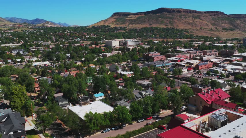 Downtown Golden historic West of Denver small town Colorado aerial drone Front Range Rocky Mountains Foothills summer morning blue sky sunny Table Mountain Mesa neighborhood landscape forward pan up