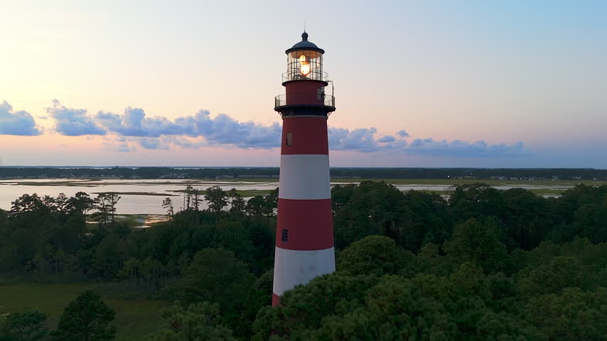 The Assateague Lighthouse At Sunset On The Virginia Eastern Shore In Virginia, USA. Aerial Wide Shot