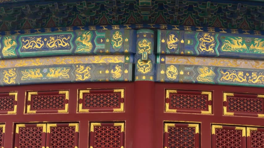 Decorative traditional Chinese wooden architecture with golden dragon pattern. Ancient temple detail with intricate ornate carvings. Cultural heritage and history of Asia landmark.