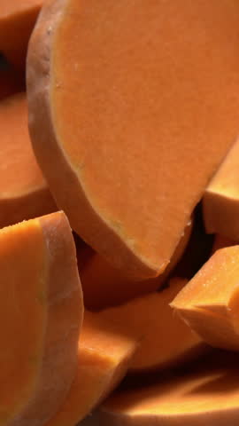 Close-up of sliced pumpkin pieces. Pumpkin pie filling. Making a holiday pie. Vegetable dishes