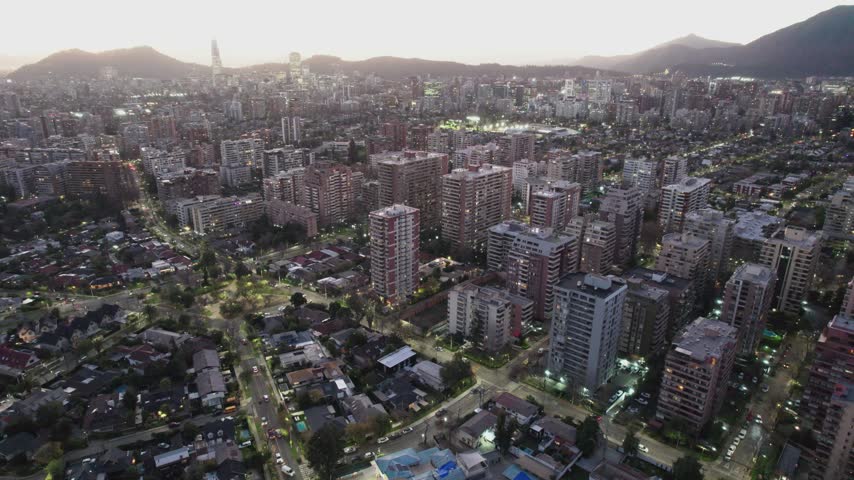 Elevated Drone View Of Santiago Cityscape With Lit Buildings At Twilight, Chile