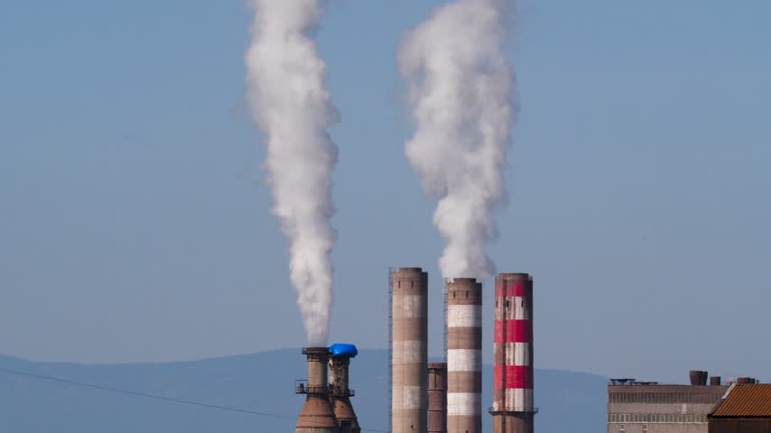 Footage of toxic waste and smoke coming out of the chimneys of industrial facilities and polluting the environment.
