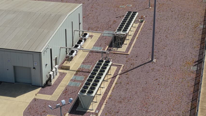 Aerial view of Triton Knoll offshore windfarm 400220kV substation with industrial cooling fans and gravel grounds in Boston, England, United Kingdom.