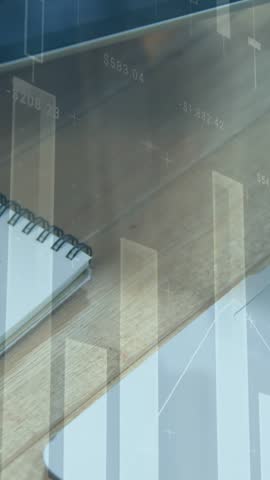 Animation of multiple graphs, overhead view of caucasian man writing in notepad on desk. Digital composite, multiple exposure, report, business, office and technology concept.