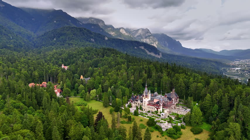 Popular tourist destination located in the evergreen woods. Drone flight near the Pele? Castle in the Carpathian Mountains, Romania.