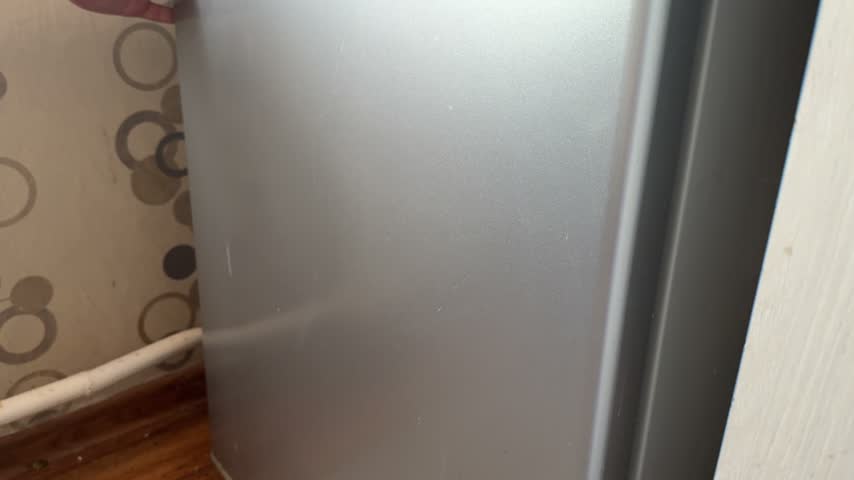 Close up of opening refrigerator door.