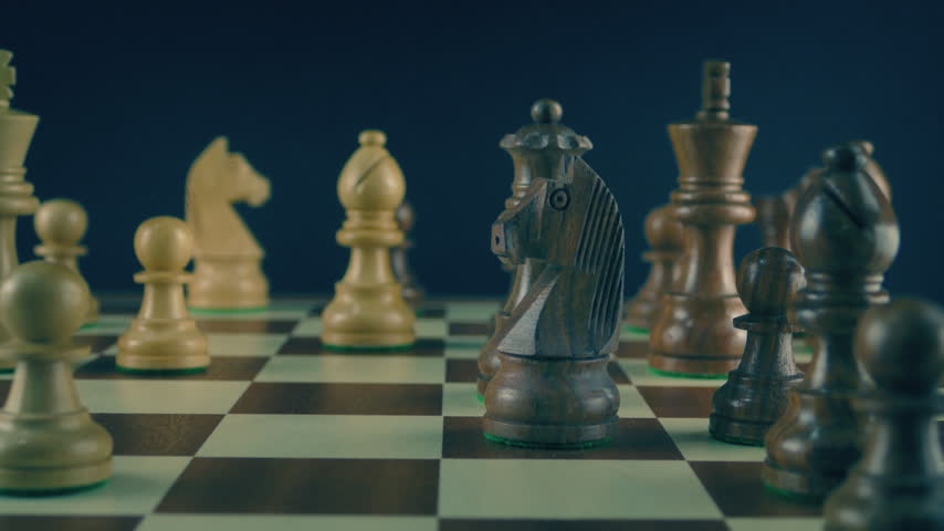 Man Moves Queen Playing Chess Closeup