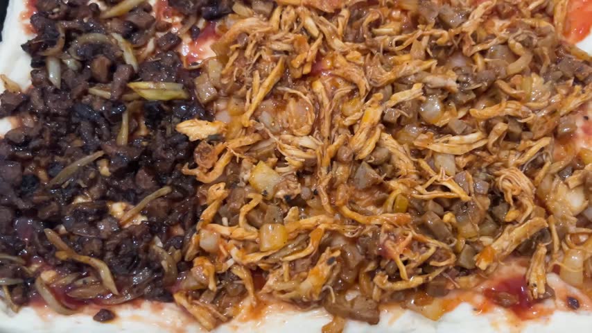 Hand Sprinkling Shredded Cheese on Fresh Homemade Pizza Toppings