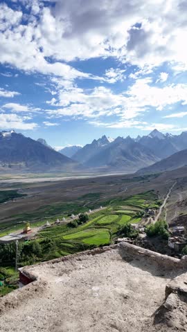 Zanskar, India : Panoramic aerial footage of Karsha Gompa, the largest Buddhist monastery in Padum of Zanskar valley in Ladakh, India showing golden stupas surrounded by beautiful mountain range 
