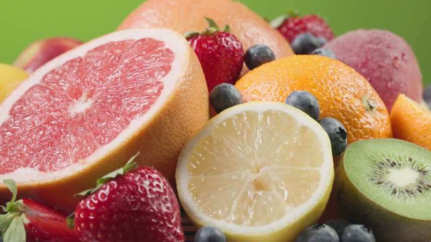 assorted fresh colorful fruits and berries rotating in a vibrant composition. Juicy peach, orange, strawberries, blueberries, kiwi, and grapes showcase natural freshness, rich textures, and vivid colors. Premium food video ideal for healthy eating, vitamins, summer, nutrition, organic produce, smoothies, desserts, grocery, and food advertising concepts.