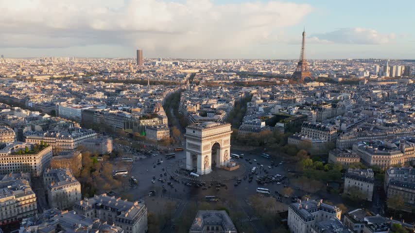 Aerial view of the Arc de Triomphe and the Eiffel Tower overlooking the historic cityscape of Paris, Ile-de-France, France.