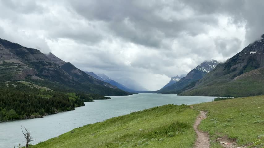 Waterton Lakes National Park. The mountains rise in the background under a cloudy sky.
