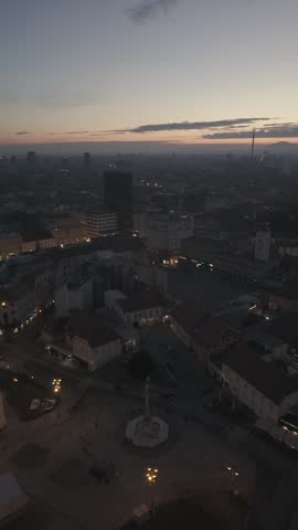 Aerial view of Zagreb Cathedral and the historic city center in Croatia. Cinematic drone shot of the gothic church towers, red rooftops, and urban skyline during daylight.