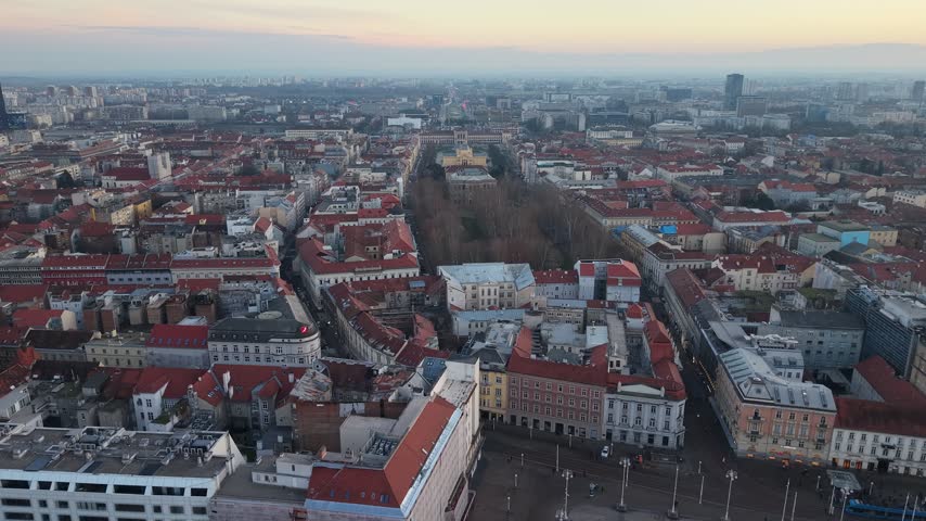 Aerial view of Zagreb Cathedral and the historic city center in Croatia. Cinematic drone shot of the gothic church towers, red rooftops, and urban skyline during daylight.