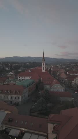 Aerial view of Zagreb Cathedral and the historic city center in Croatia. Cinematic drone shot of the gothic church towers, red rooftops, and urban skyline during daylight.
