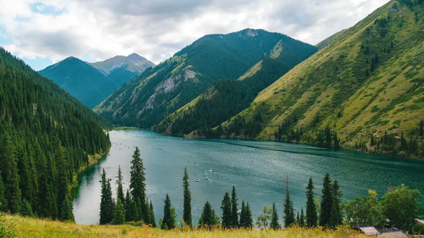 Catamarans sail on Lake Kolsai in Kazakhstan in summer