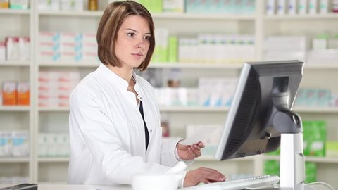 Smiling pharmacist chemist woman with prescription in pharmacy drugstore