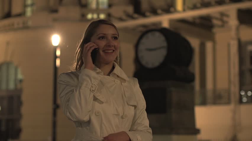 women on the phone looking at watch on time appointment  
