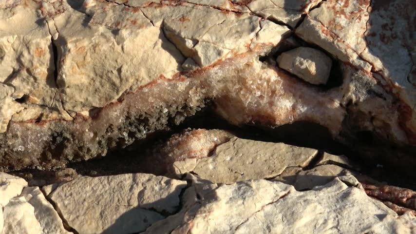 Kas, Turkey - 11 of March 2026: Viewing raw calcite crystal formation inside rock fissure

