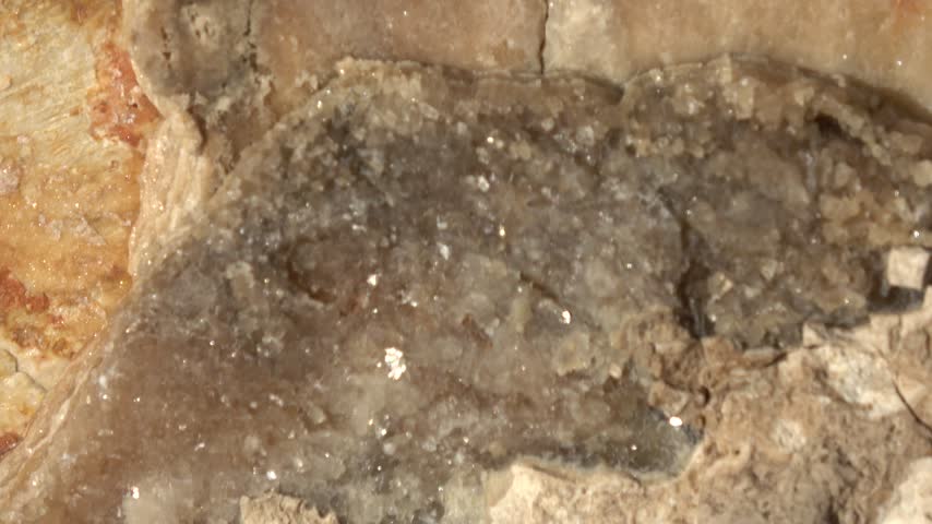 Kas, Turkey - 11 of March 2026: Zoom out Macro shot of grey calcite crystals embedded in limestone rock fissure
