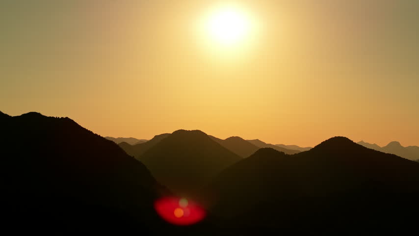 Aerial view of sunset over mountains along the road embankment at Skadar Lake, Montenegro.