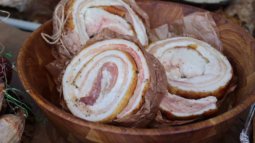 Close Up of Traditional Rolled Salo with Meat and Spices. Cured Pork Fat, Artisan Meat Delicacy and Traditional Food. Rolled Cured Pork Fat with Meat