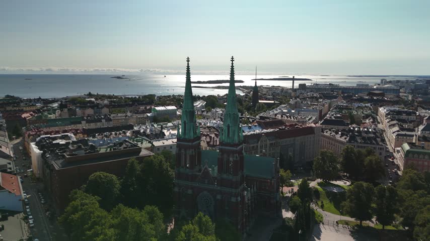 Drone panorama of St Johns Church and the surrounding Helsinki cityscape showing dense buildings streets green areas and historic urban architecture