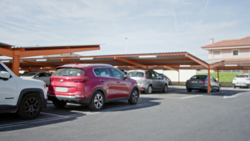 Parking lot with covered carports and soft blurred bokeh background outdoor; backplate copyspace backdrop calm.