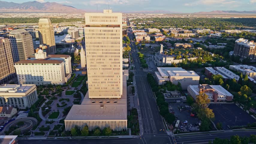 Golden sunrise light glows over the panoramic aerial view of the Salt Lake Temple at Temple Square