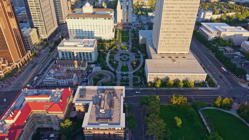Golden sunrise light glows over the panoramic aerial view of the Salt Lake Temple at Temple Square