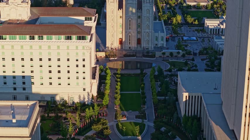 Golden sunrise light glows over the panoramic aerial view of the Salt Lake Temple at Temple Square