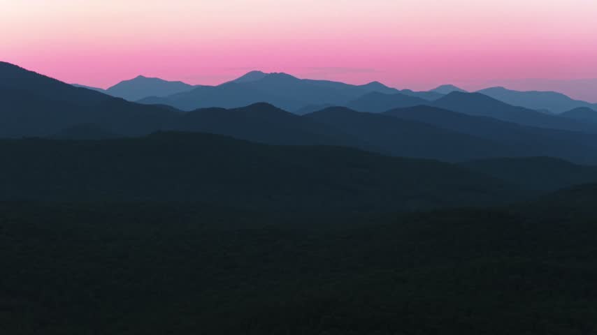 Vibrant blue hour sunset Adirondack Mountain Upstate New York above Schroon Lake aerial drone view Adirondack High Peaks layers New York State Mount Severance Pharaoh Lake Wilderness forward upwards