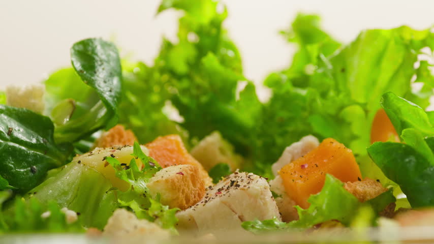 Caesar Dressing or Creamy Sauce Pouring Over Fresh Green Caesar Salad Leaves in Bowl, Close Up of Healthy Food Preparation, Restaurant and Cafe Cooking Concept