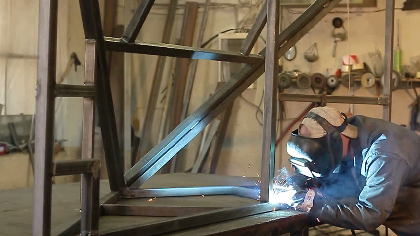 Worker working with welding in a workshop