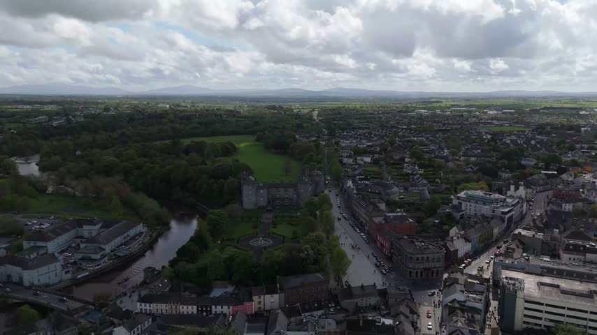 Aerial view of Kilkenny Castle surrounded by lush gardens and the historic town of Kilkenny, County Kilkenny, Ireland.