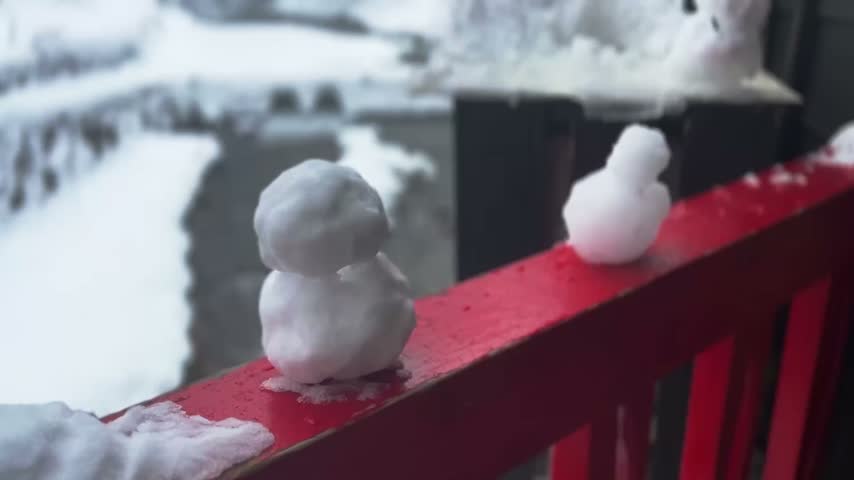 Small Snowman on Red Railing in Ginzan Japan