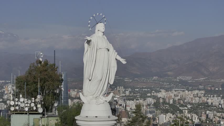 The statue of the Virgin of Santiago from San Cristóbal Hill Santiago, Chile and the aerial view of the Andes Mountains