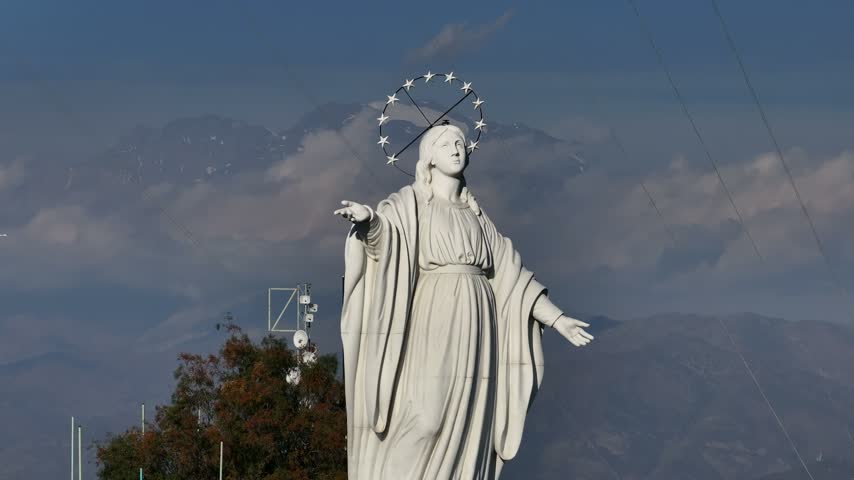 The statue of the Virgin of Santiago from San Cristóbal Hill Santiago, Chile and the aerial view of the Andes Mountains