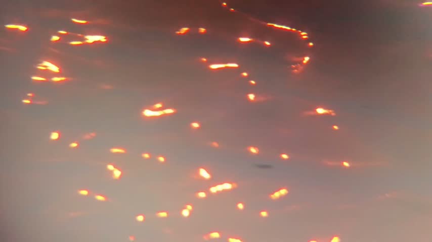 Glowing light reflections dancing on water surface bbackground