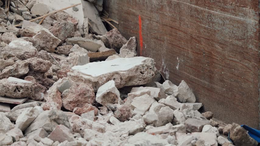 Close-up of large pile of broken concrete and construction debris, demolition waste rubble, close-up video footage. High quality 4k footage