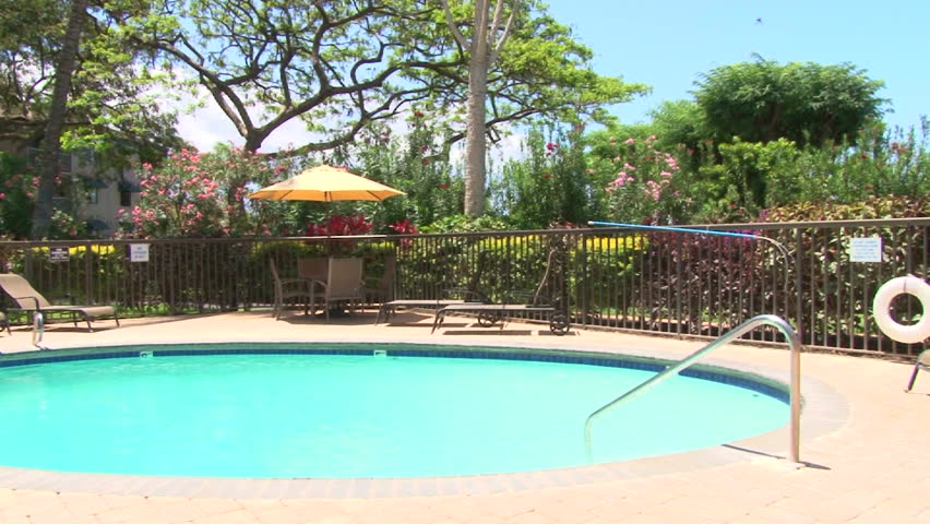 Swimming pool scenic at tropical resort in Hawaii, panning shot.