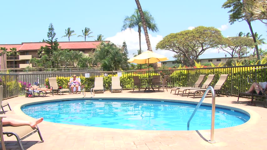 Swimming pool scenic at tropical resort in Hawaii, tilt down.